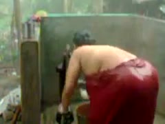 An amateur, ugly Indian fatso attempts to shower outside.